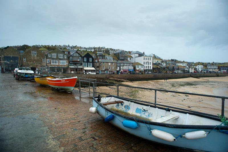 Small fishing boats and tenders on the quayside at St Ives, Cornwall