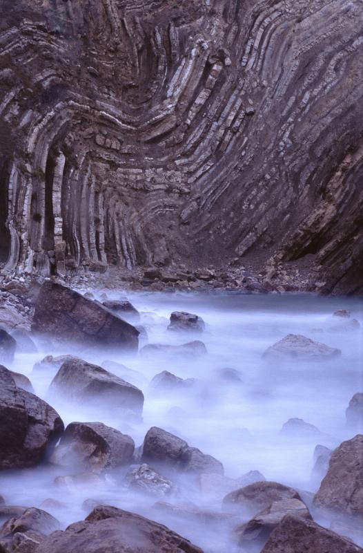 long expose image of water and contorted rock layers on the jurassic coast