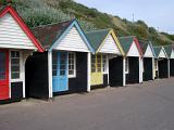 a row of beach huts on bournemouth promenade