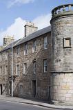 Street level view on round corner of stone block building in Saint Andrews, Scotland