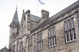Close up of second floor of town hall with flag waving at top in Saint Andrews, Scotland