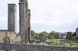 Stone barrier in front of old graveyard and towers of Saint Andrews Cathedral in Scotland with copy space in sky