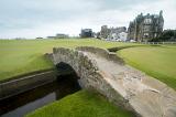 Green grass covered golf course with little stone Swilken bridge in Saint Andrews, Scotland