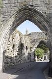 Old Medieval stone entrance arch, St Andrews, Scotland with a narrow road passing underneath to the second arch in a travel and tourism concept
