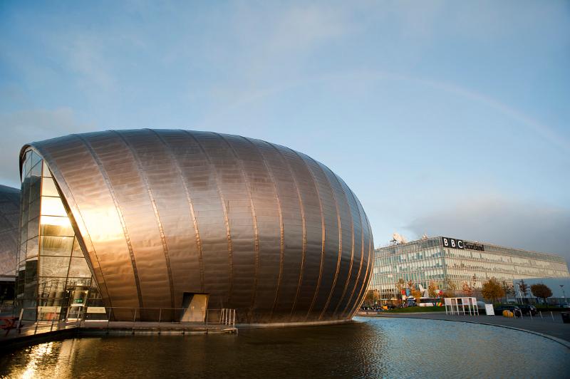 Glasgow Princes Dock Development with the curved metal clad facade of the Glasgow Science Centre on the River Clyde