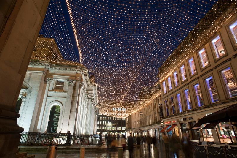 Royal Exchange Square and GOMA, Glasgow at night with a low angle view of the exterior facade of the Gallery Of Modern Art and the display of illuminated Christmas lights above