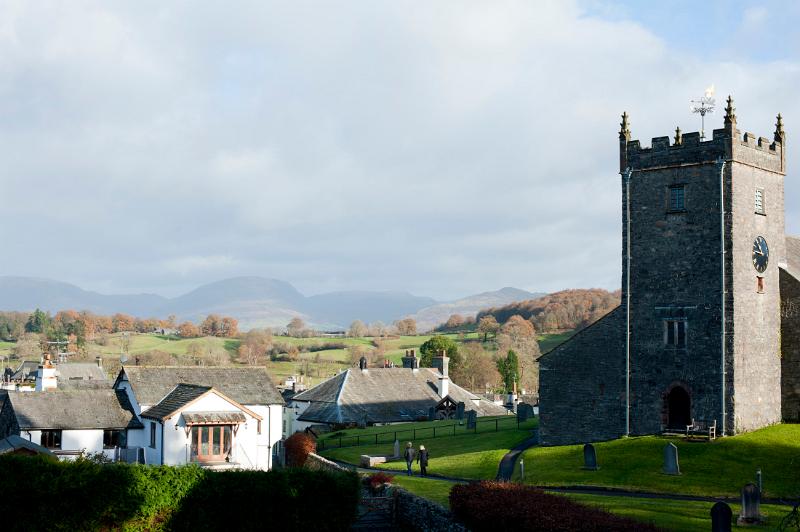 Old stone church and cottages in Hawkshead in Cumbria, one of the most popular tourist villages in the English Lake District