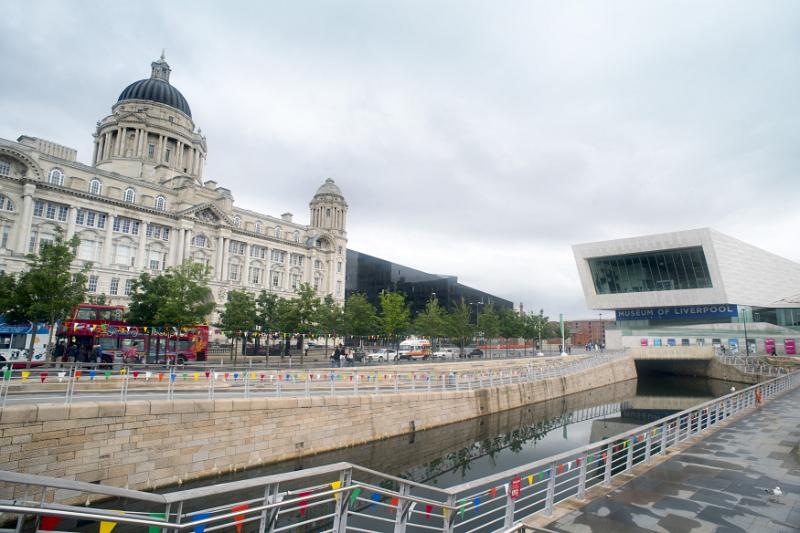 Narrow canal at end of museum of Liverpool Narrow canal with railing and steps leading to the Museum of Liverpool, with the Port of Liverpool Building in the background in the United Kingdom