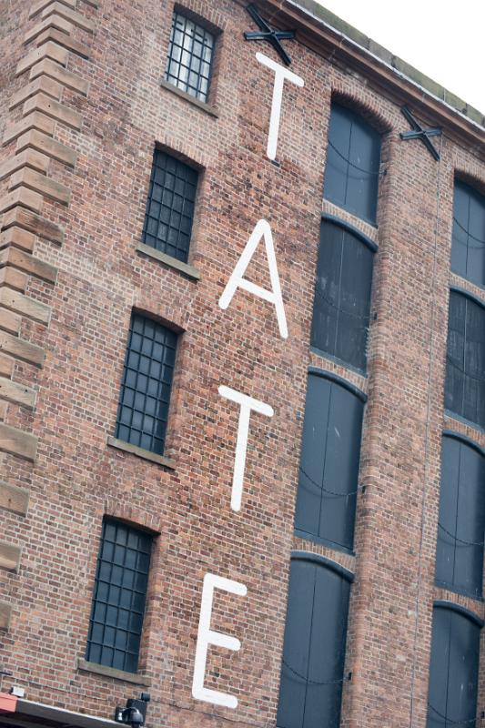 TATE letters painted on brick of old building TATE letters painted on brick of old building at the famous Liverpool Albert Dock in the United Kingdom