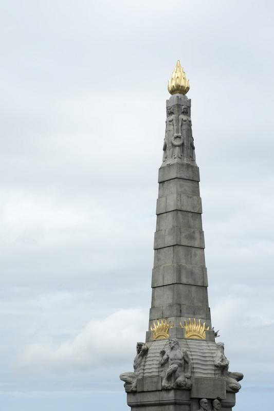 Golden colored torch ornament on top of stone  pinnacle in Liverpool, memorial to those lost on the Titanic, United Kingdom