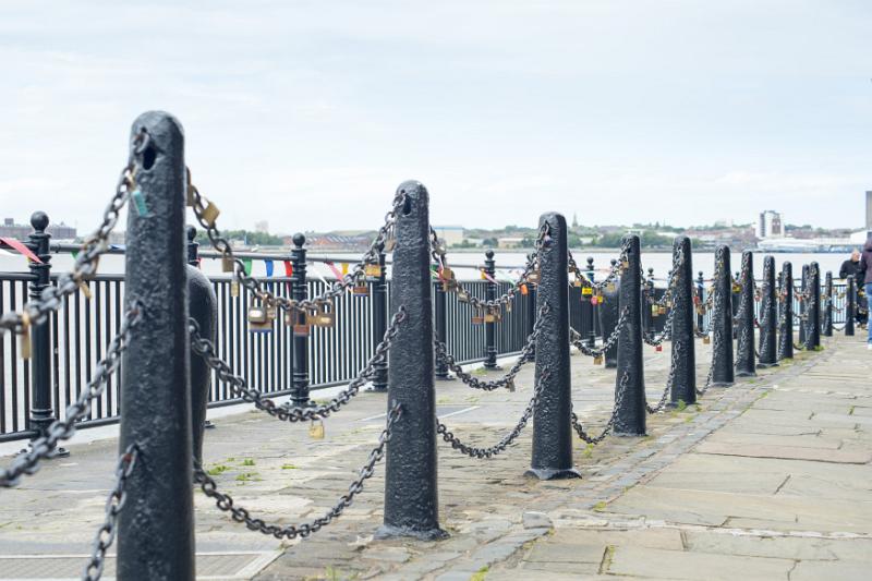 Various padlocks on iron chains at waterfront at Liverpool Mersey waterfront in the United Kingdom