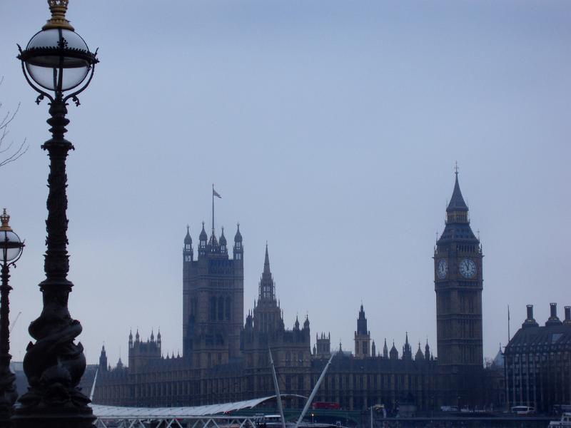 Misty view of an old victorian lamppost and the Palace of Westminster, London with the iconic Houses of Parliament and Big Ben clock tower