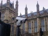 Westminster, London, security showing a mounted surveiilance camera and closed circuit tv on a perimeter fence with the building behind