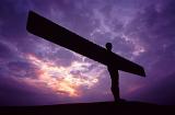 Angel of the North sculpture silhouetted against a colourful purple sky at sunset, Gateshead, Newscastle