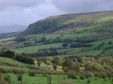 Lush green valley and hill in the Welsh countryside on a wet cloudy day