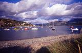 Boats moored in the sheltered water of the harbour at Barmouth, Wales in a picturesque landscape view