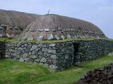Traditional blackhouse on the Hebrides with its thatched roof and double drystone walls inside which an open fire was built with no chimney so the smoke had to seep through the thatch