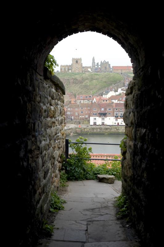a narrow stone passage leads through to a flight of steps into the town from the west cliff