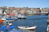 boats moored in the upper harbour of whitby, the swing bridge can be seen at the right leading to the lower harbour