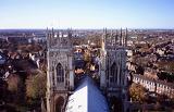Aerial view of the twin towers on York Minster cathedral overlooking the city and skyline on a sunny blue sky day