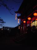 Night scene of a traditional Chinese house with colorful lighted lanterns hung at the entrance as a welcome to visitors