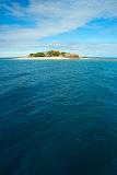View across open ocean with copyspace to South Sea Island, an idyllic small Fijian resort island