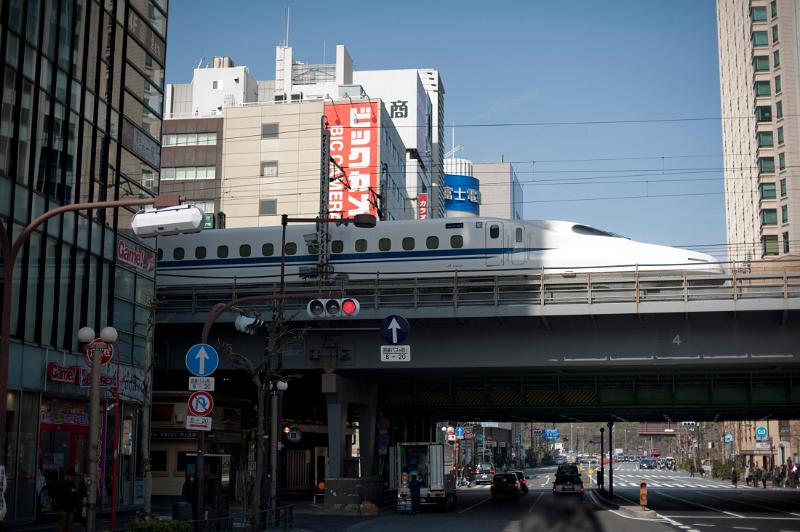 a bullet train crossing a bridge in Ginza, Tokyo, Japan