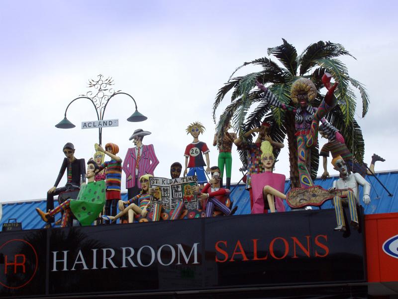 Hairroom Salon Signage at St Kilda Hairroom Salon Building Signage with Artistic Human Sculptures on Rooftop at St Kilda in Melbourne, Australia.