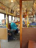 Random Few Seated Passenger Riding in Australian Tram in Melbourne