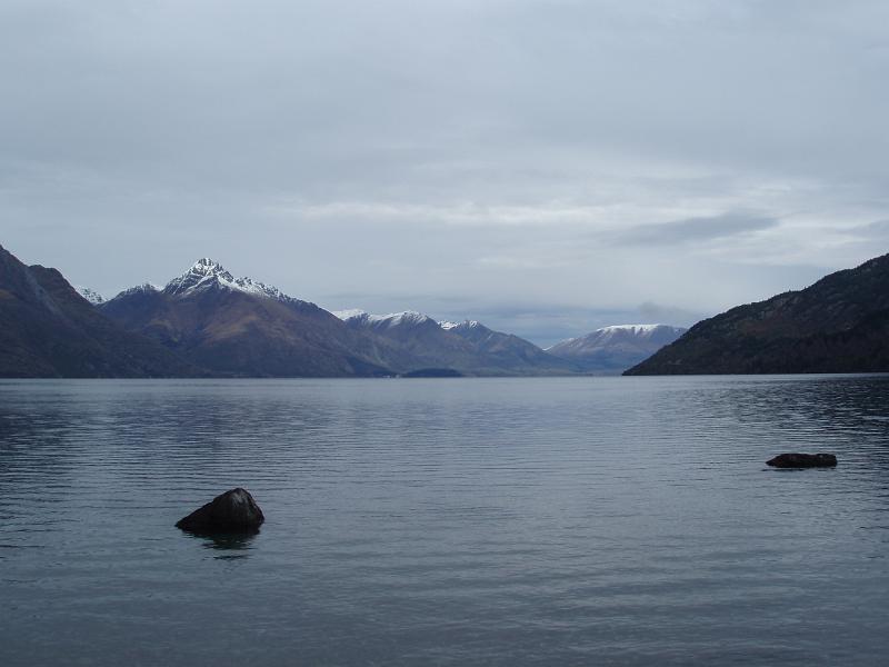serene view of lake wakatipu, on a grey day in  queenstown, newzealand