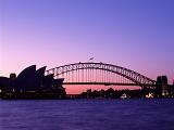 Silhouette of Sydney Harbor Bridge and Opera House with Purple Sunset