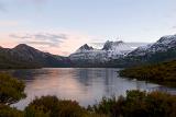 sunset over dove lake, a snow covered cradle mountain in the background