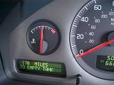 Fuel gauge on a motor vehicle showing a half full tank and a digital readout of the remaining range of the car at 170 miles