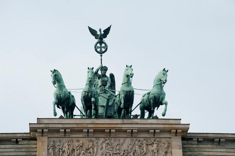 Quadriga - roman chariot with four hourses on top of the brandenburg gate, berlin