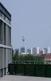 View of high-rise architecture in Berlin with the Fernsehturm TV tower and antenna towering above them