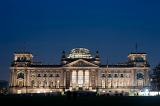 a view of the reichstag including it's famous dome floodlit at night