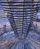 Inside the glass dome of the Reichstag Building in Berlin with tourists enjoying the panoramic view of the city