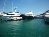 a row of expensive super yachts docked at a st martin marina