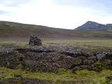 Iceland country cairn or stone marker on volcanic rocks in remote countryside
