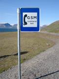 Mobile phone point with a sign indicating that their is a GSM signal available at this point at the side of a remote road in Iceland