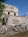 Ancient Disfigured Building Structure at Chichen Itza. Isolated on Blue Sky Background.