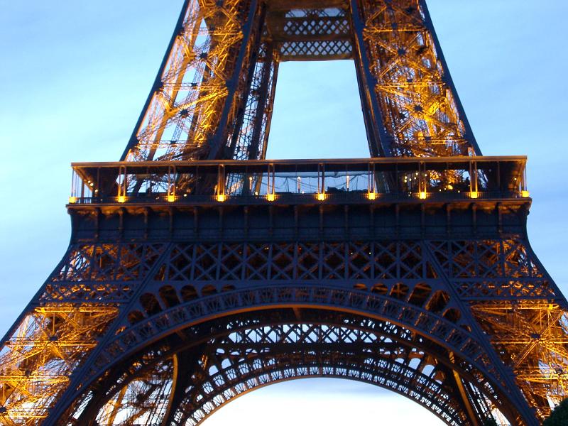 Detail of the Eiffel Tower, Paris, France showing the structure of the wrought iron lattice framework of the tower against a blue sky