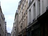 Old Vintage Architecture - Buildings Along Narrow Paris Street. with a Light Blue Sky Background.