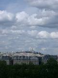 Overview of Basilique du Sacre Coeur and Paris Cityscape with Large Cloudy Sky