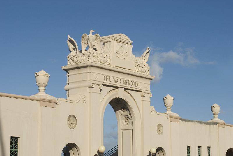 Old Vintage Concrete Arch at Waikiki Natatorium War Memorial in Honolulu. Isolated in Light Blue Sky Background.