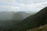 Looking out across mountain ranges on a wet misty day from Pali Lookout, Ohau, Hawaii, USA