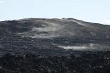 Black volcanic hill of solidified smoking lava in Volcanoes National Park, Hawaii