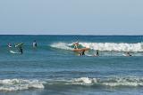 Surfers surfing at Waikiki beach, Hawaii, a favorite tourist destination and surfers paradise