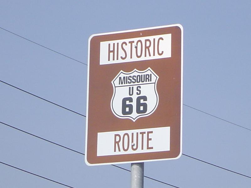 Close up Historic Missouri 66 Route Signage Isolated on Light Blue Gray Sky Background.