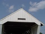 Detail of a historical white painted covered wooden bridge entrance in Madison County, Iowa, USA